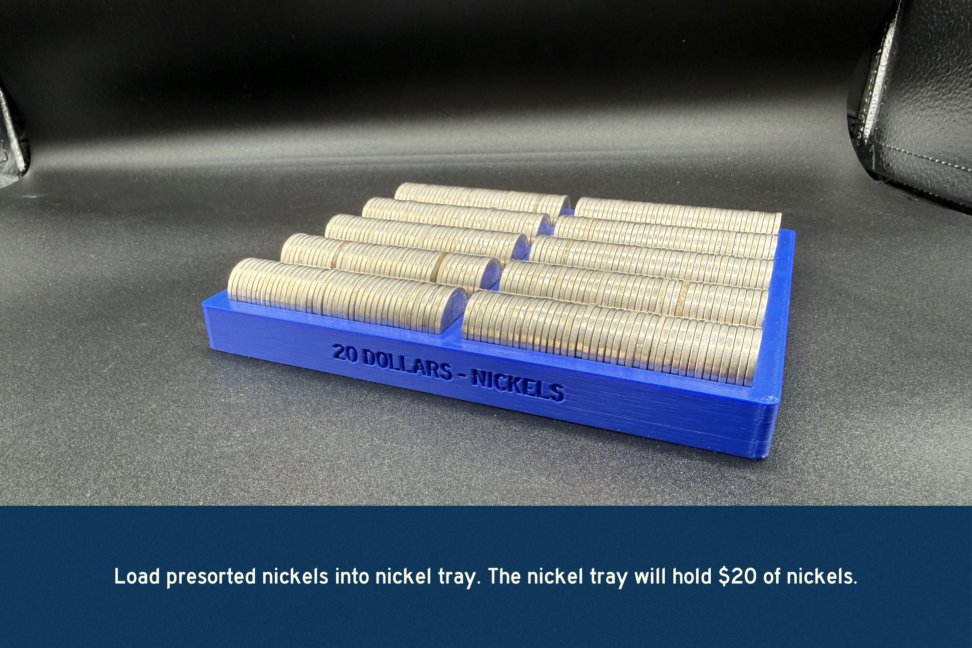 Blue nickel tray with rolls of nickels on a gray surface